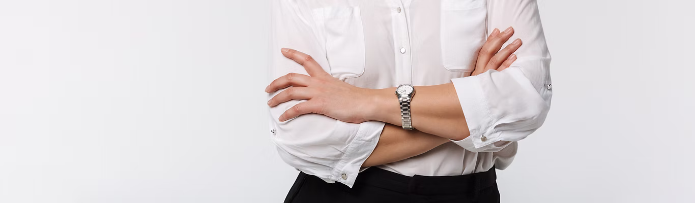 confident Businesswoman standing with arms crossed and smiling.
